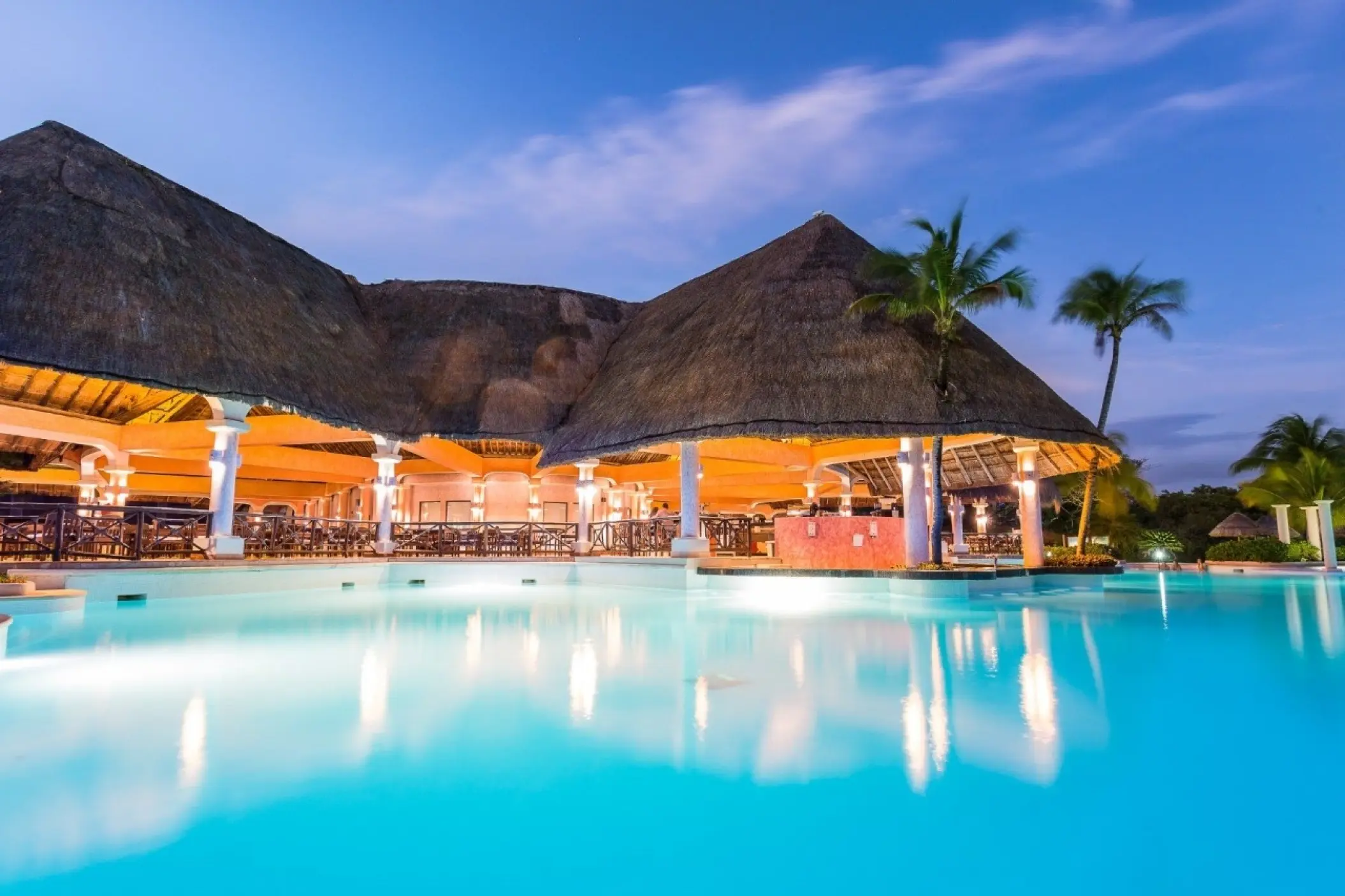 Grand Palladium Colonial lit up at night beside a pool, Riviera Maya