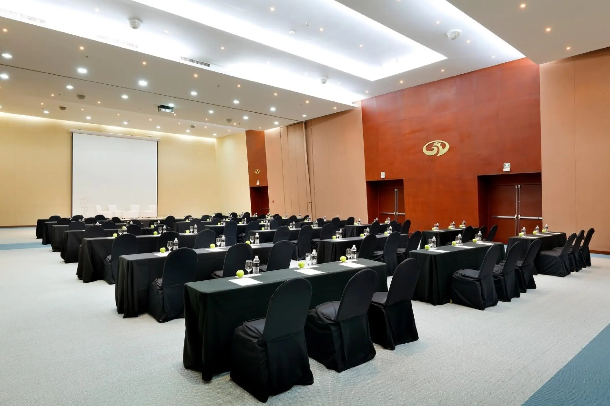 Indoor conference center with rows of tables and black chairs at Grand Palladium Colonial, Riviera Maya