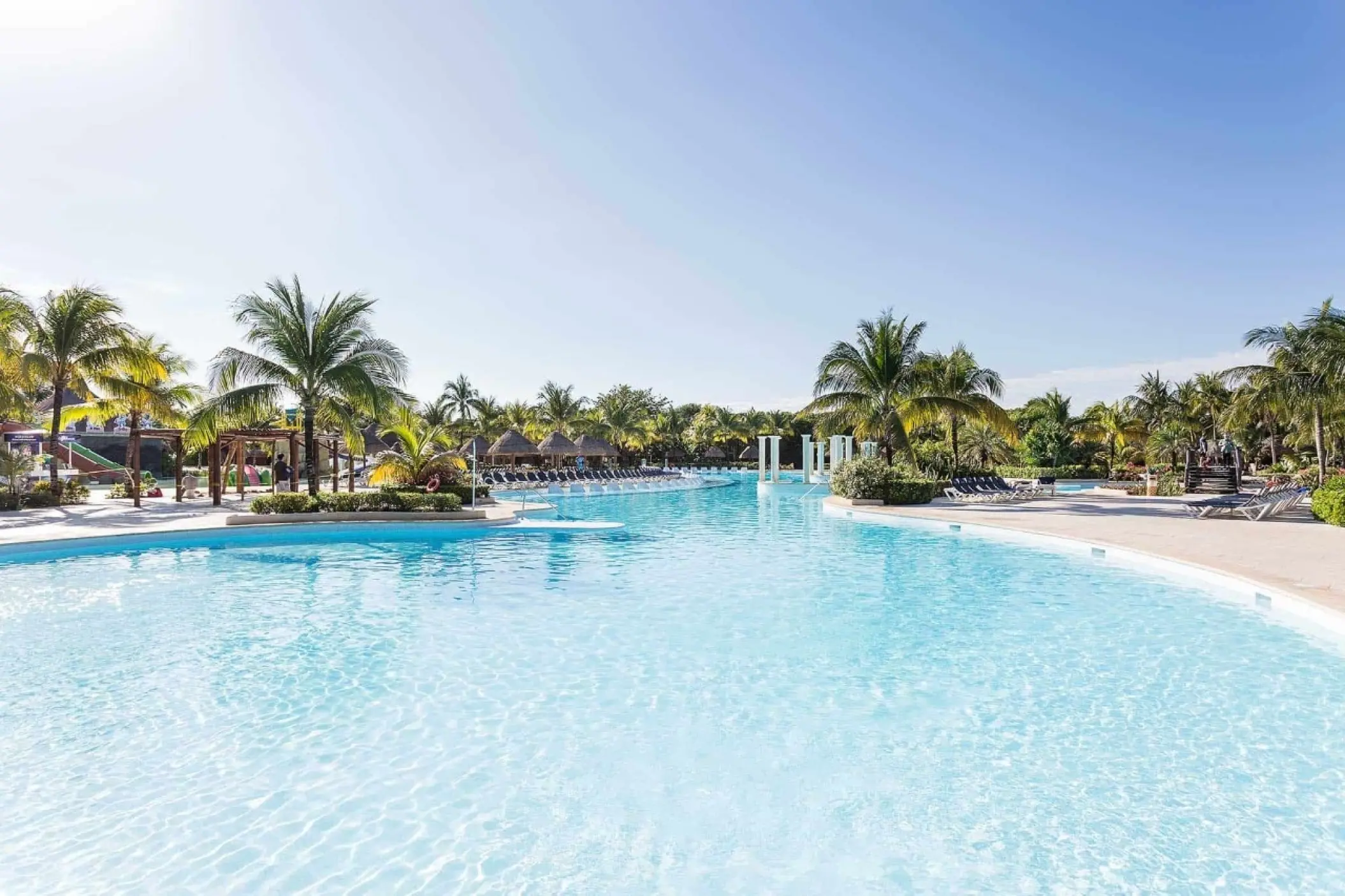 Grand Palladium Colonial expansive pool surrounded by palm trees, Riviera Maya
