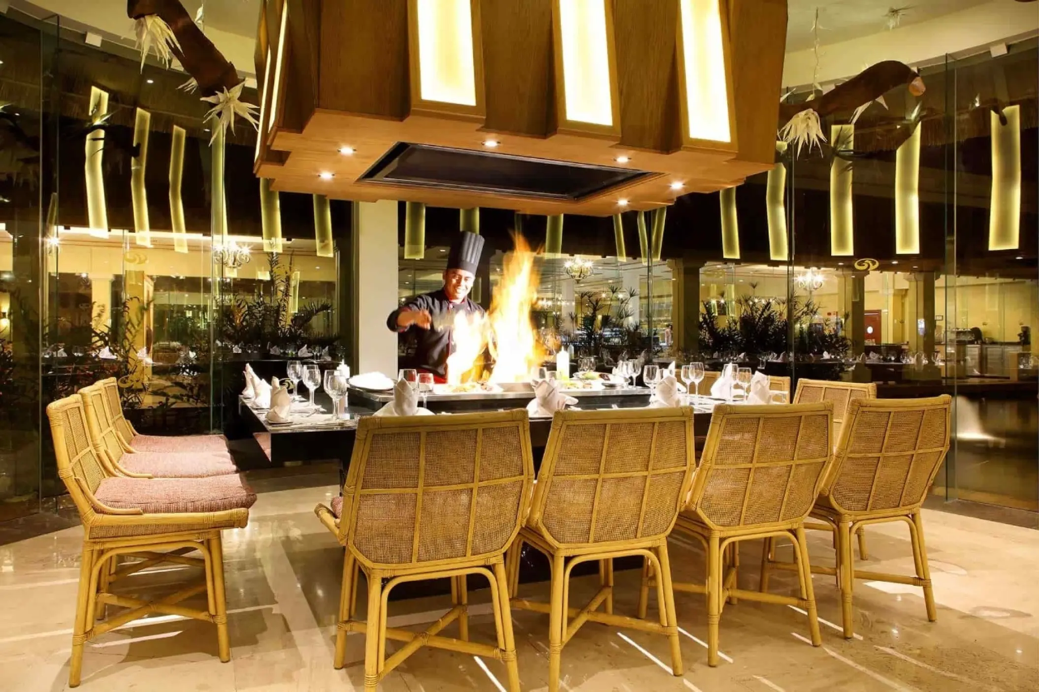 Chef preparing a teppanyaki dinner with a large flame at Grand Palladium Colonial, Riviera Maya