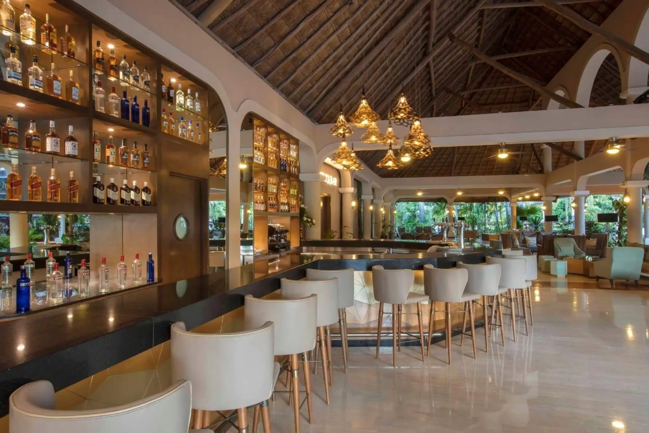 Bar area with high-top stools and a vaulted wooden ceiling at Grand Palladium Colonial, Riviera Maya