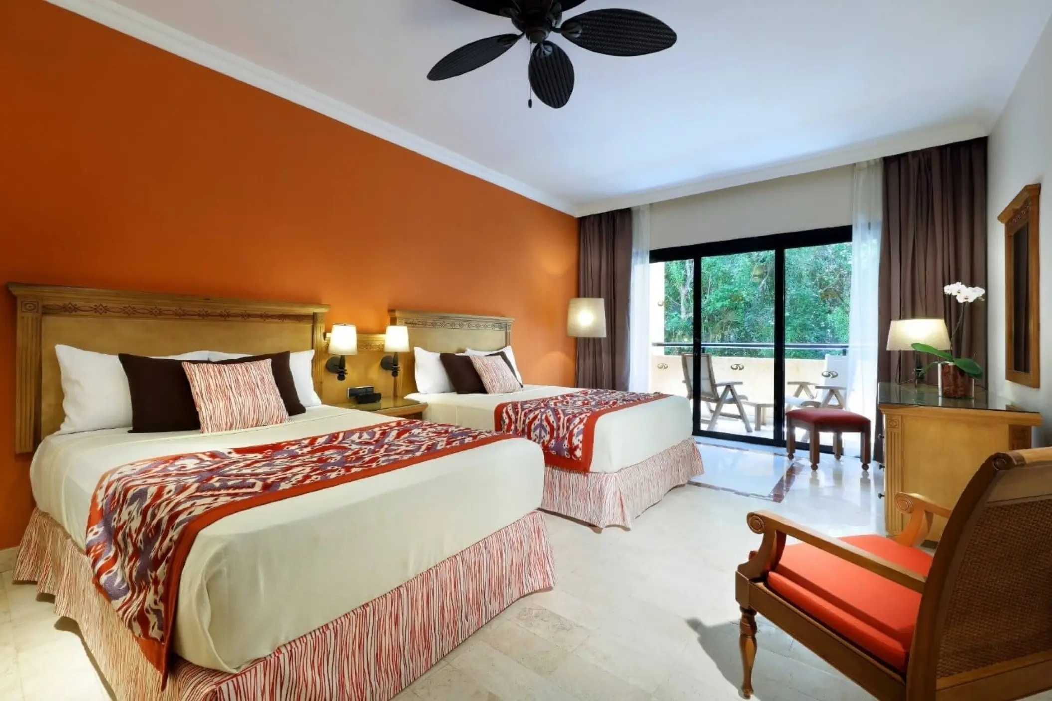 Guest room with two beds and orange accent wall at Grand Palladium Colonial, Riviera Maya