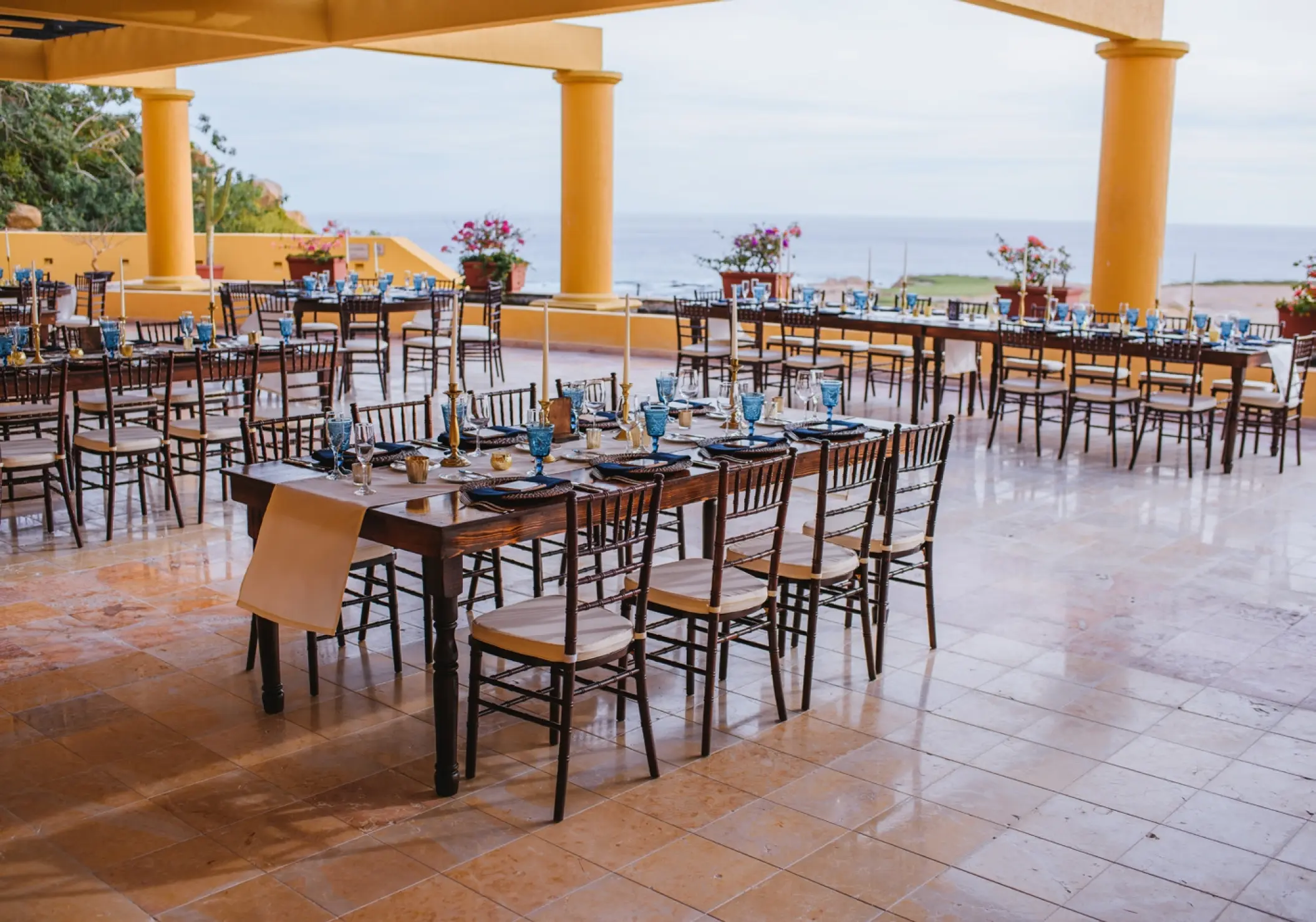 Fairway Terrace wedding reception with long wooden tables at Grand Fiesta Americana Los Cabos, Cabo San Lucas