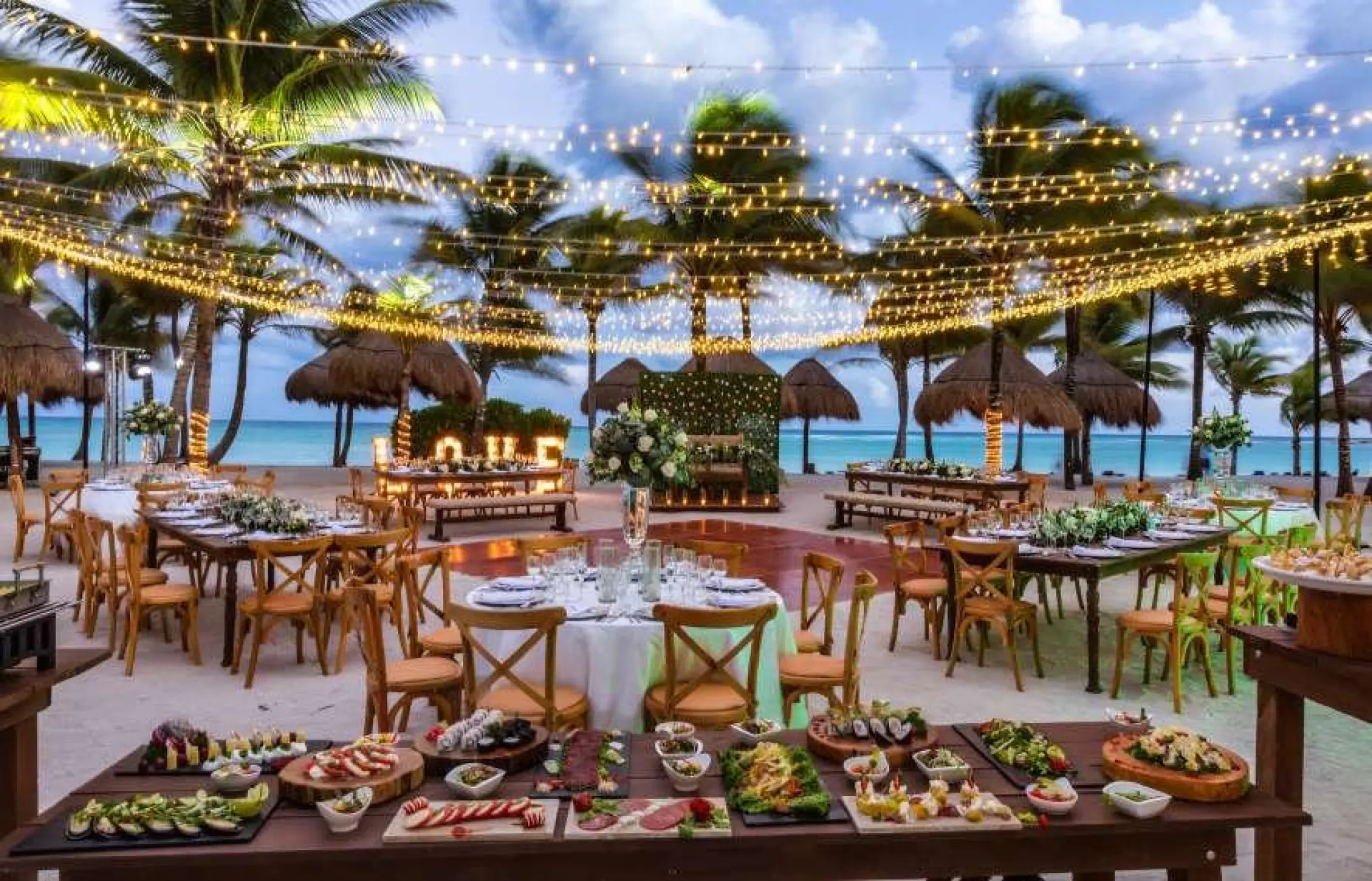 Beachfront wedding reception under string lights at Grand Palladium Colonial, Riviera Maya