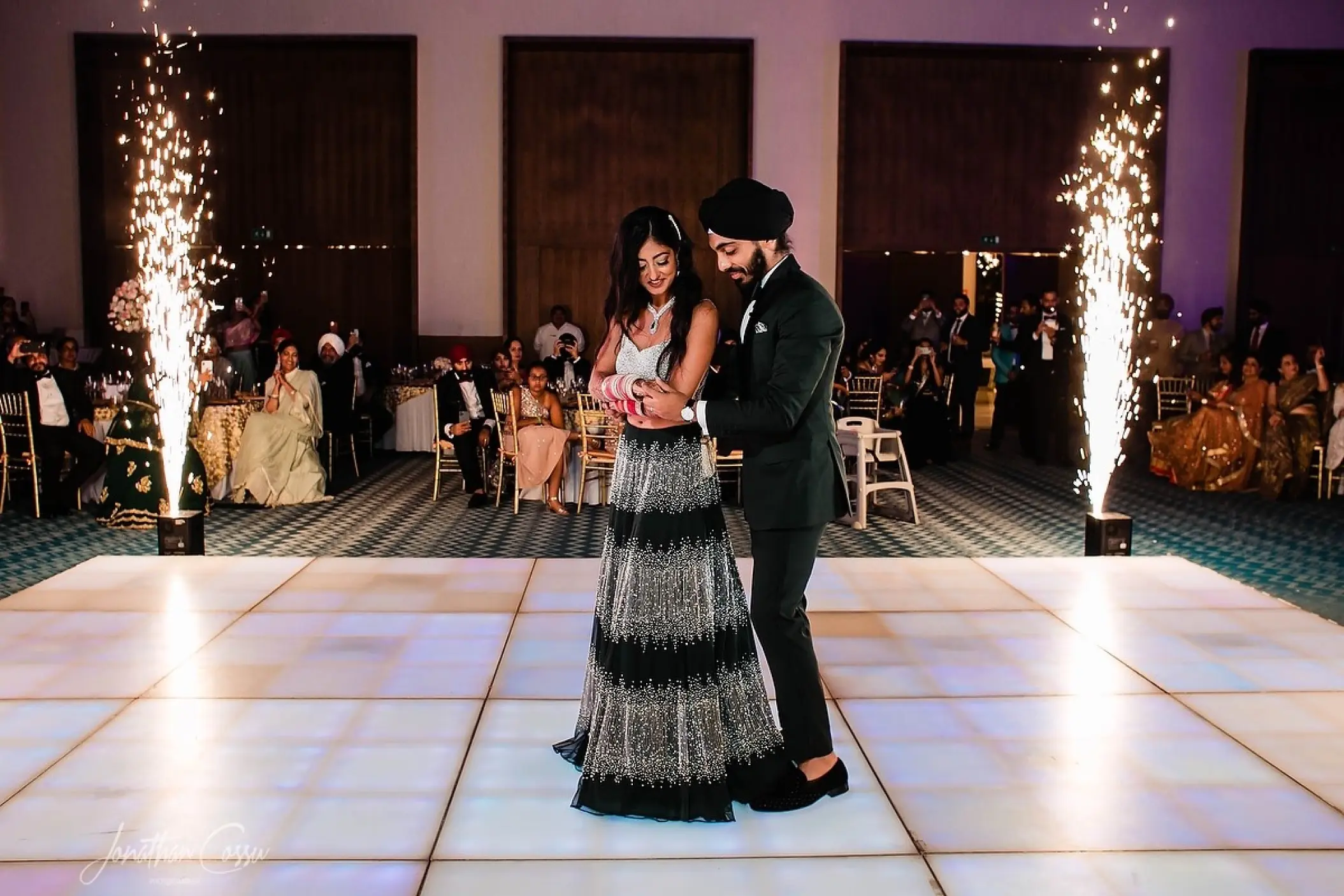 Indoor wedding reception at Grand Palladium Costa Mujeres with a couple dancing between cold sparklers, Cancun