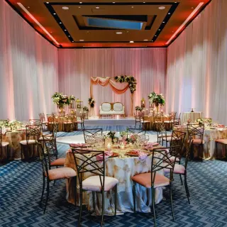 Indoor wedding reception with pink linens and floral decor at Grand Palladium Colonial, Riviera Maya