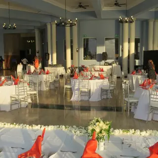 Indoor wedding reception with white linens and red napkins at Grand Palladium Jamaica, Ocho Rios