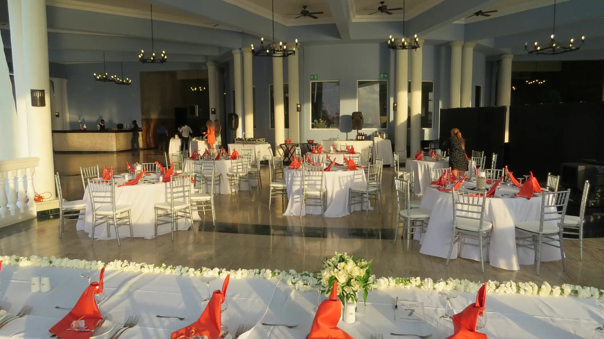 Indoor wedding reception with white linens and red napkins at Grand Palladium Jamaica, Ocho Rios