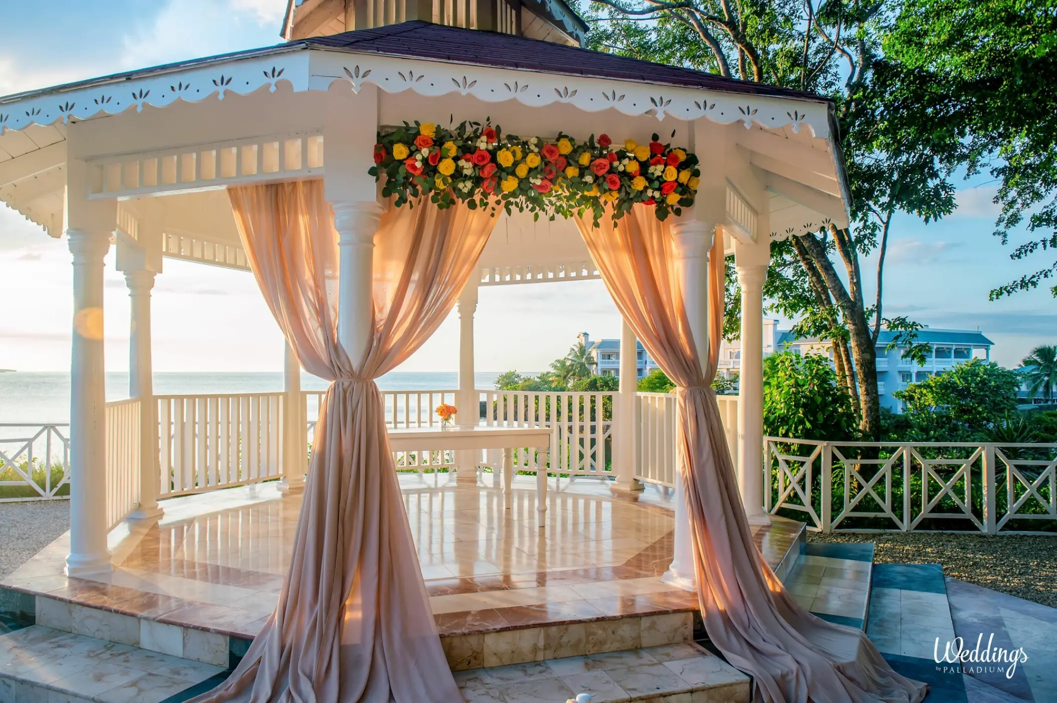 Oceanfront wedding ceremony gazebo with draped fabric and flowers at Grand Palladium Jamaica, Ocho Rios