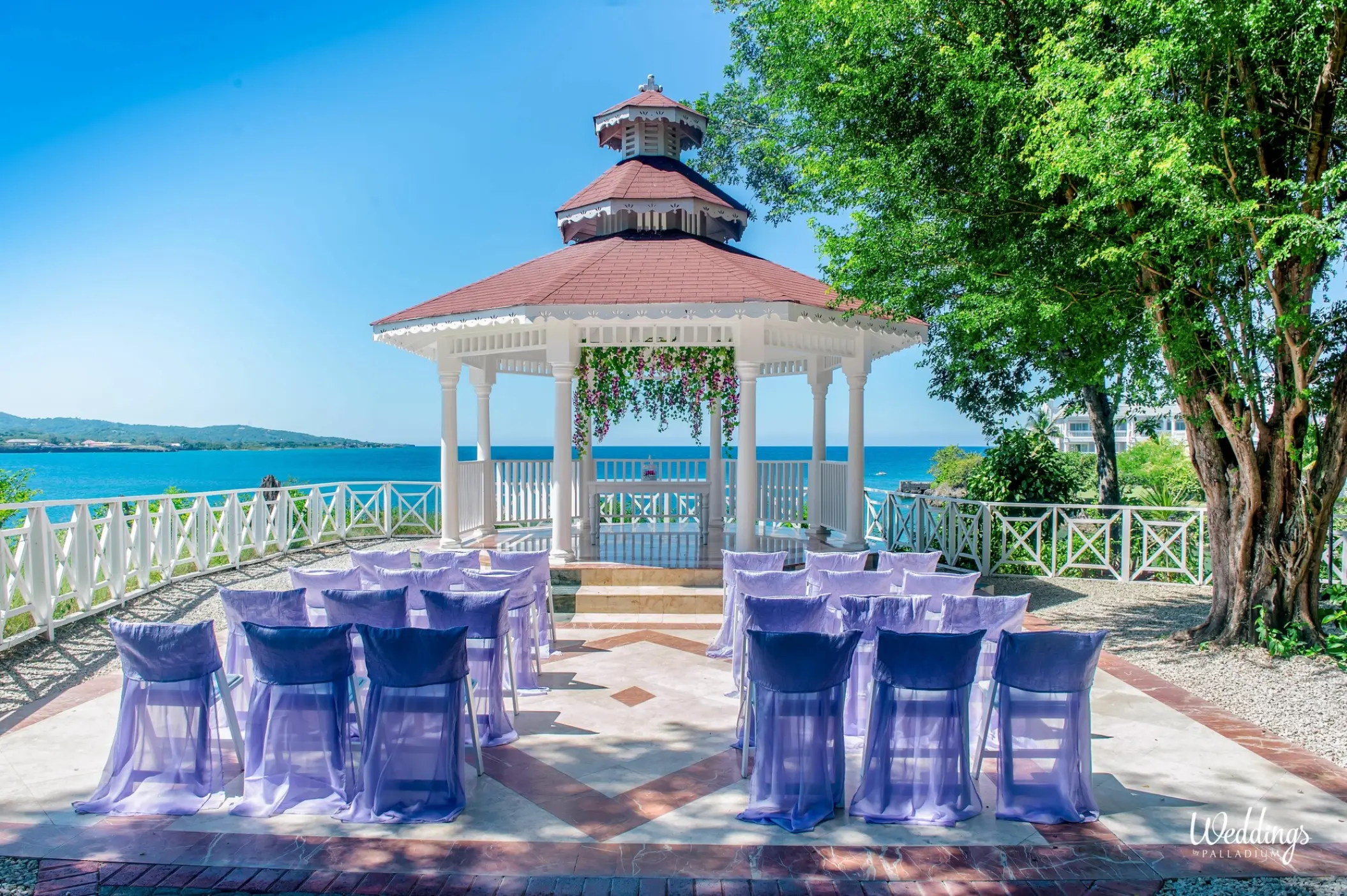 Cliffside gazebo wedding ceremony with purple chair covers at Grand Palladium Jamaica, Ocho Rios