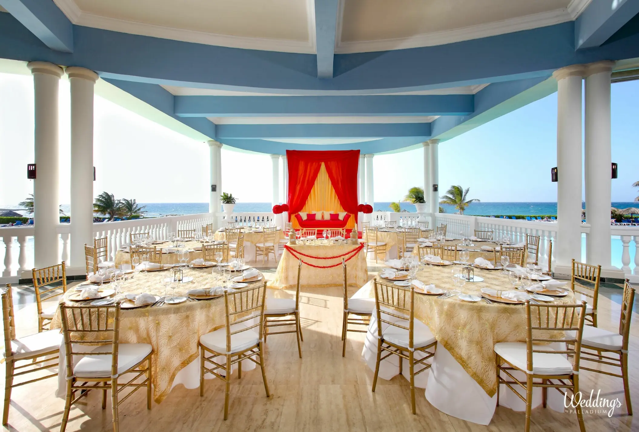 Covered terrace wedding reception with gold linens at Grand Palladium Jamaica, Ocho Rios