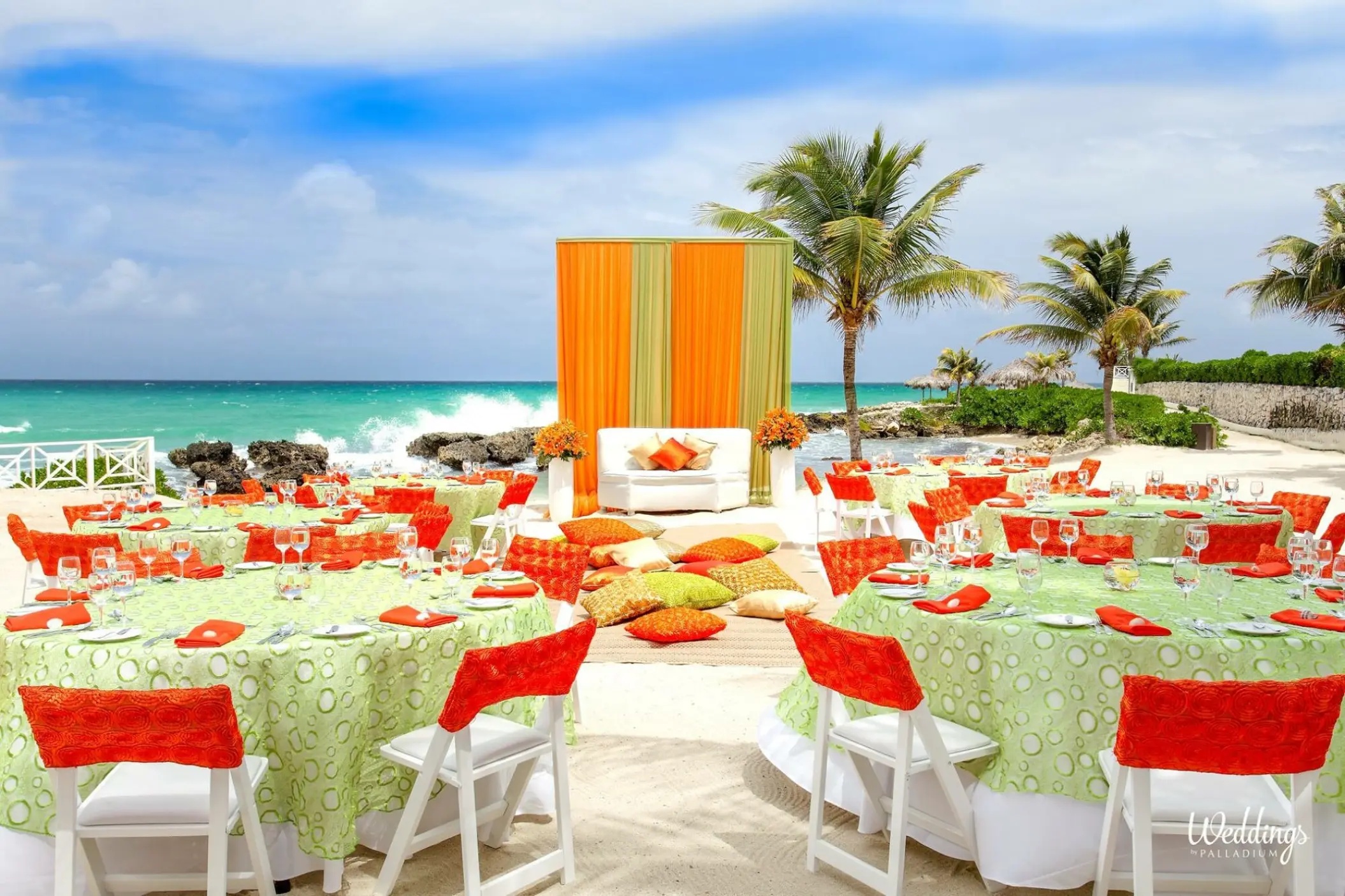 Beachfront wedding reception setup with green and orange decor at Grand Palladium Lady Hamilton, Ocho Rios