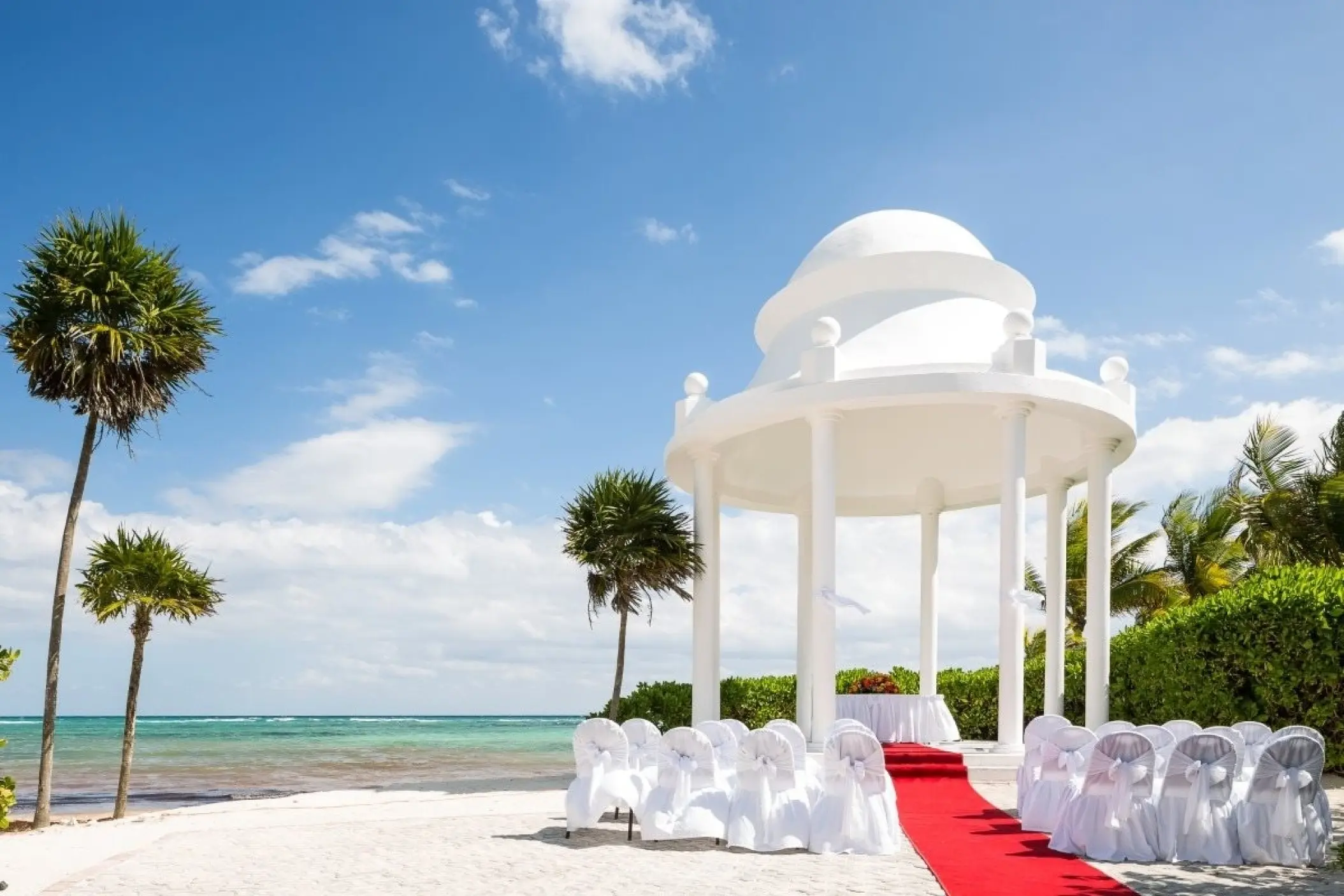 White beach gazebo with a red carpet for a wedding ceremony at Grand Palladium Kantenah, Riviera Maya