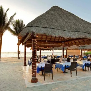 Open-air beachfront restaurant with palapa roof at Grand Palladium Kantenah, Riviera Maya