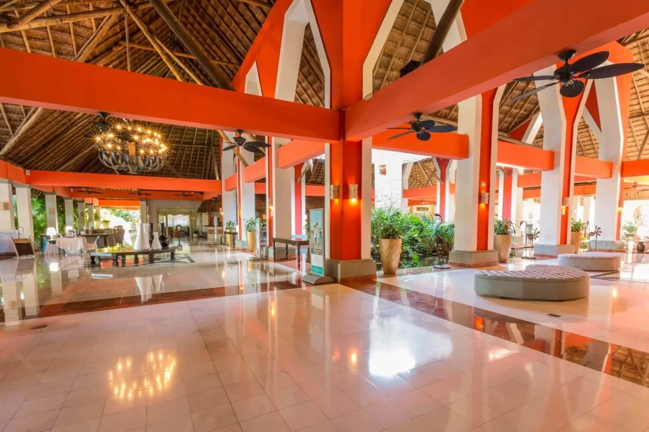 Grand Palladium Kantenah open-air lobby with orange pillars and thatched roof, Riviera Maya