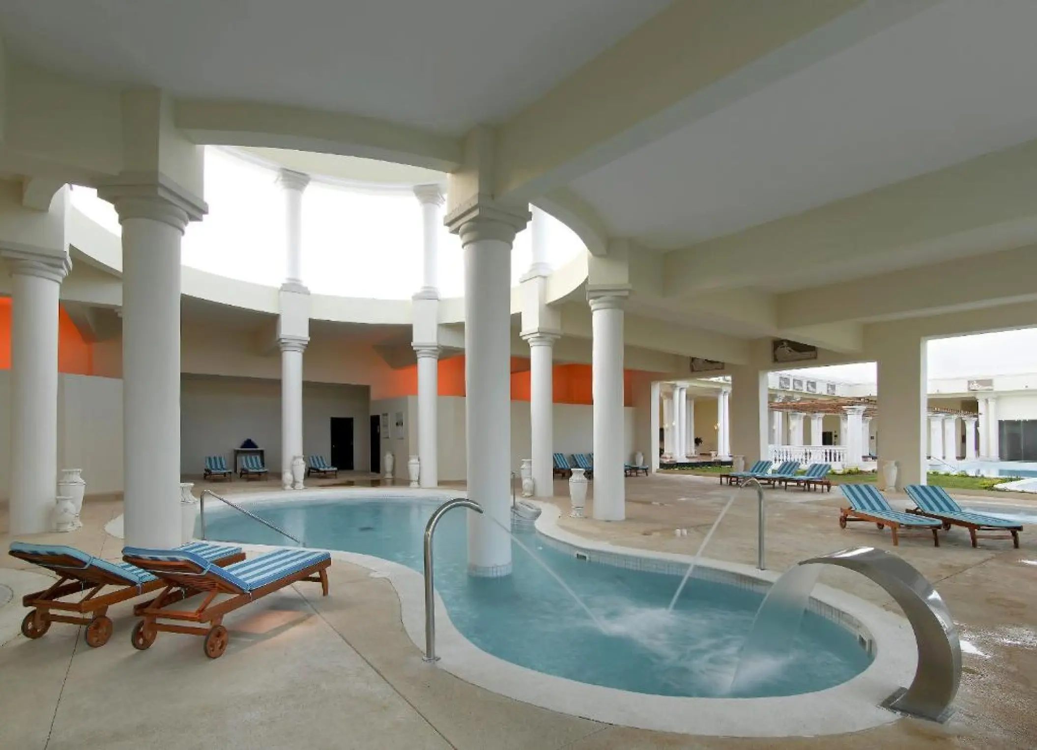 Indoor spa pool with water fountains and lounge chairs at Grand Palladium Lady Hamilton, Ocho Rios
