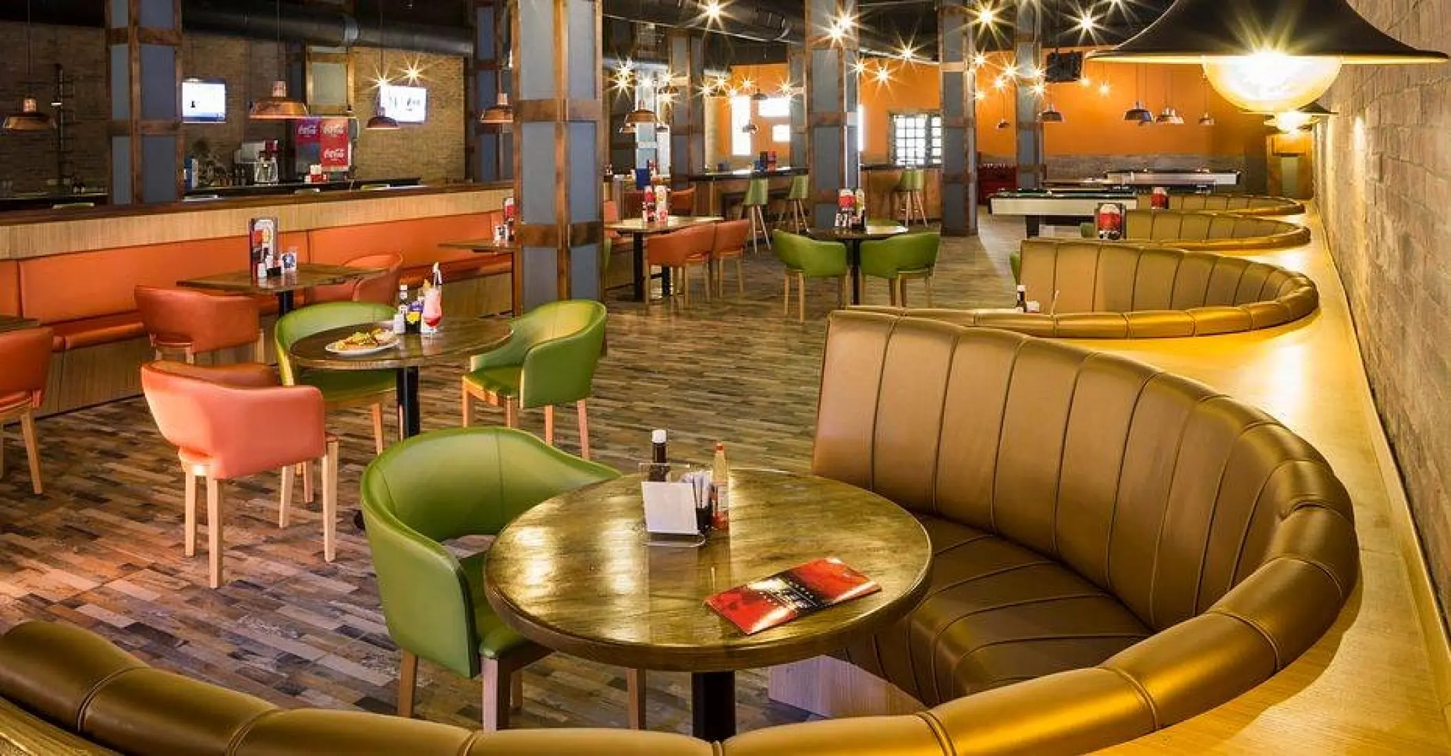 Sports bar interior with booths and table seating at Grand Palladium Lady Hamilton, Ocho Rios