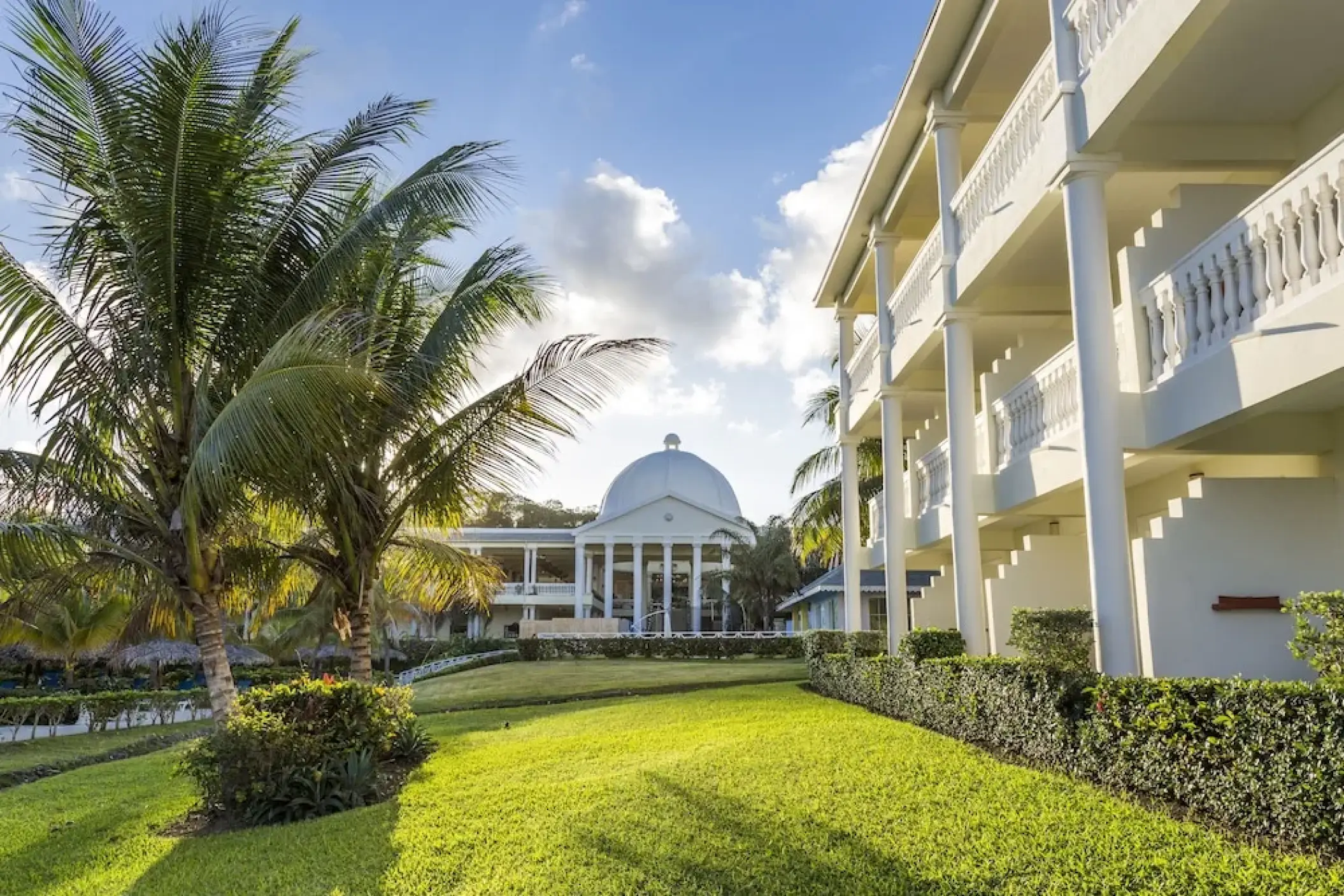 White pillared balconies and manicured lawn at Grand Palladium Lady Hamilton, Ocho Rios