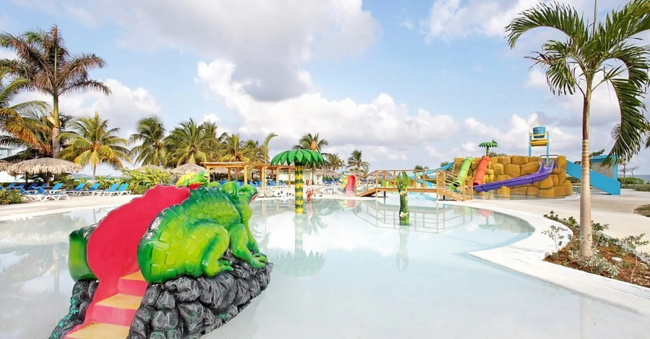 Kids water park with colorful slides and frog statue at Grand Palladium Lady Hamilton, Ocho Rios