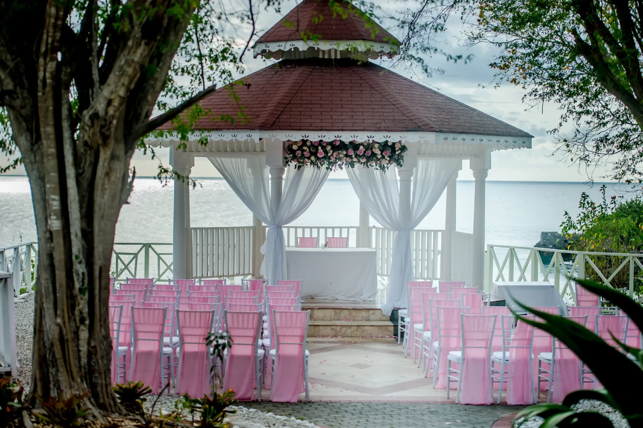 Oceanfront wedding gazebo with pink chairs at Grand Palladium Lady Hamilton, Ocho Rios