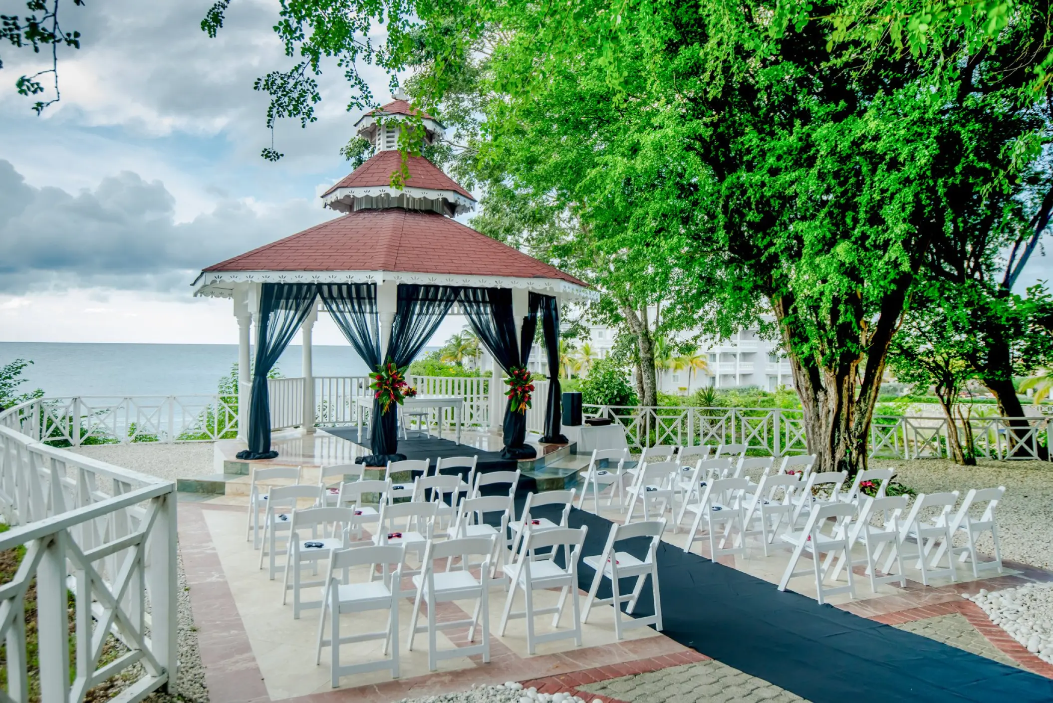 Clifftop wedding ceremony gazebo with black draping at Grand Palladium Lady Hamilton, Ocho Rios