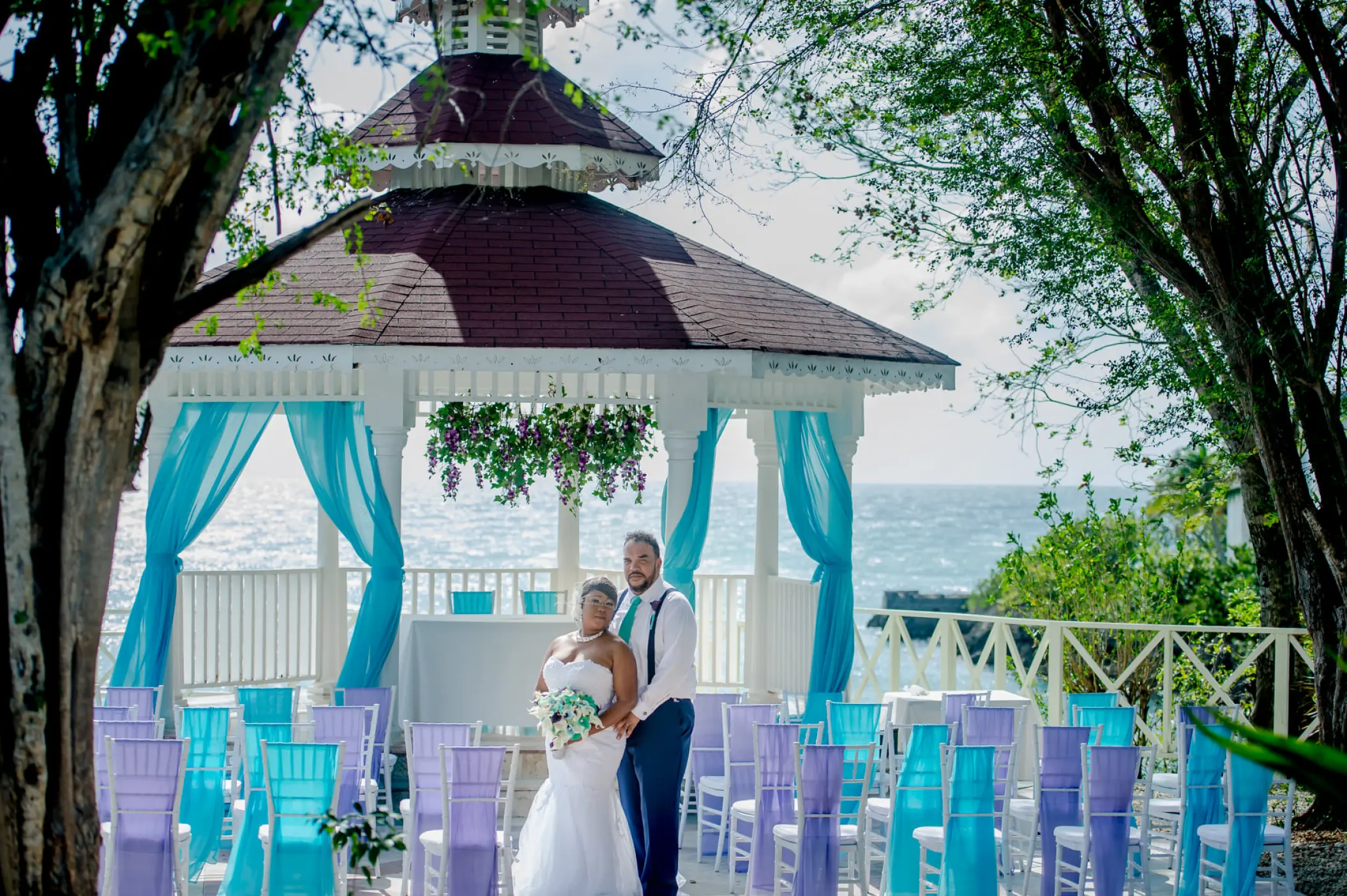 Bride and groom standing before a wedding ceremony gazebo at Grand Palladium Lady Hamilton, Ocho Rios