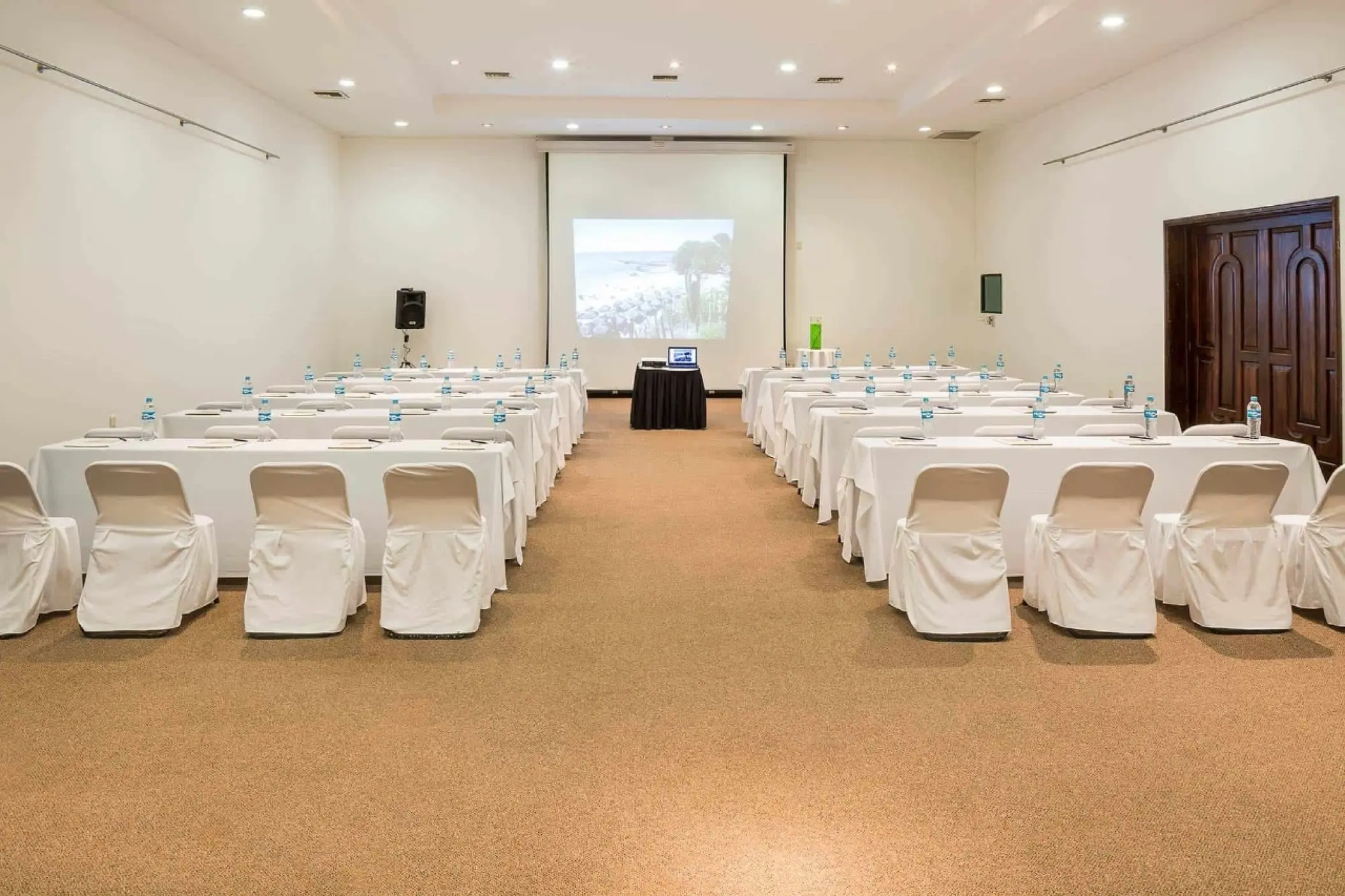 Meeting room with rows of tables and chairs in a ballroom at Grand Palladium Vallarta, Puerto Vallarta
