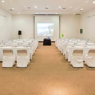 Meeting room with rows of tables and chairs in a ballroom at Grand Palladium Vallarta, Puerto Vallarta