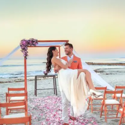Groom carrying the bride at a beach ceremony at Grand Palladium Vallarta, Puerto Vallarta