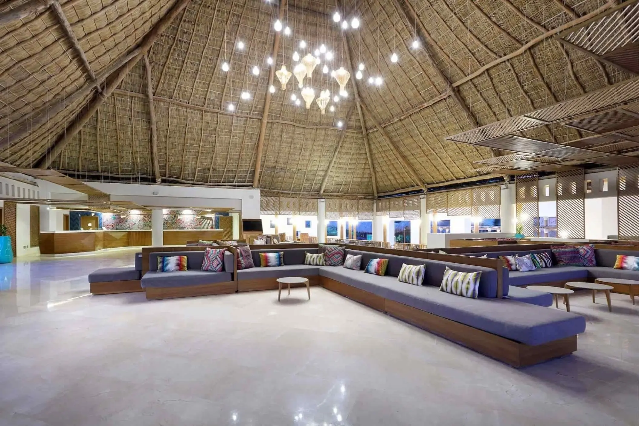 Grand Palladium Vallarta open-air lobby with a large thatched palapa roof and modern seating, Puerto Vallarta