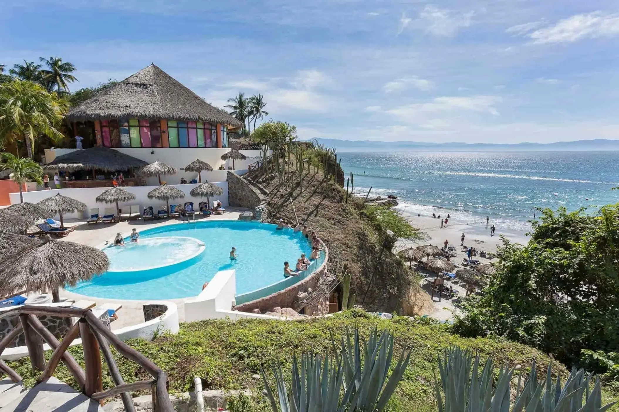 Grand Palladium Vallarta beachfront pool and palapas overlooking the ocean, Puerto Vallarta