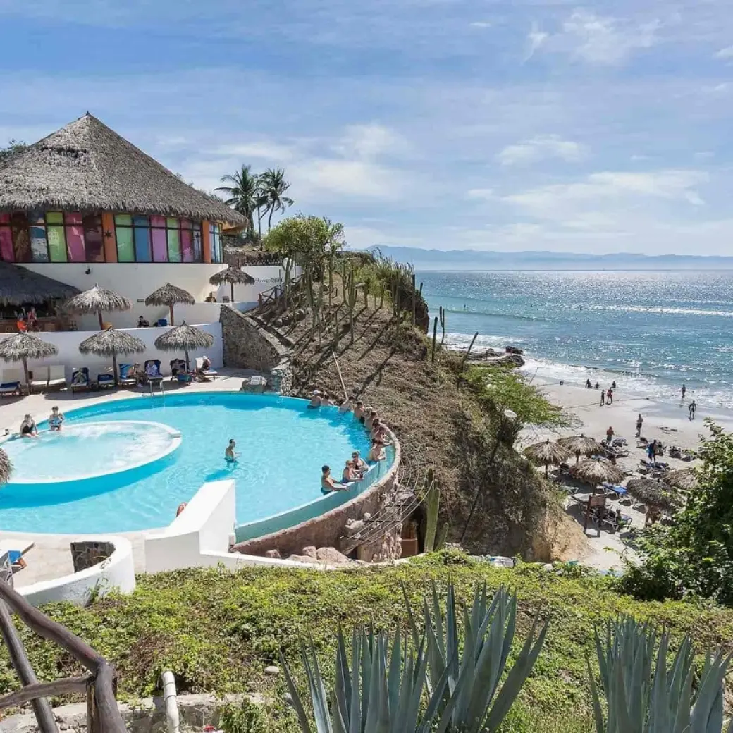 Grand Palladium Vallarta beachfront pool and palapas overlooking the ocean, Puerto Vallarta
