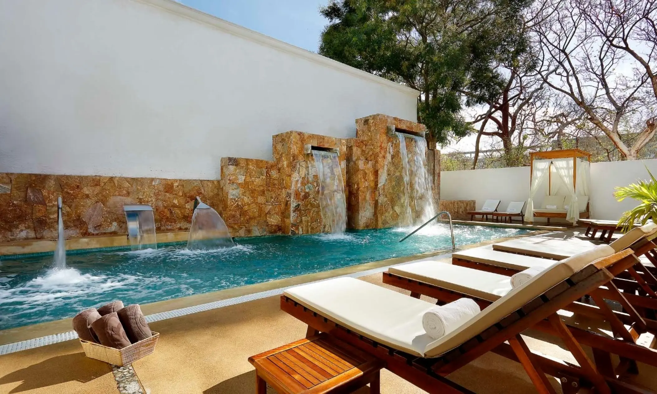 Hydrotherapy pool with stone waterfalls and lounge chairs at Grand Palladium Vallarta, Puerto Vallarta