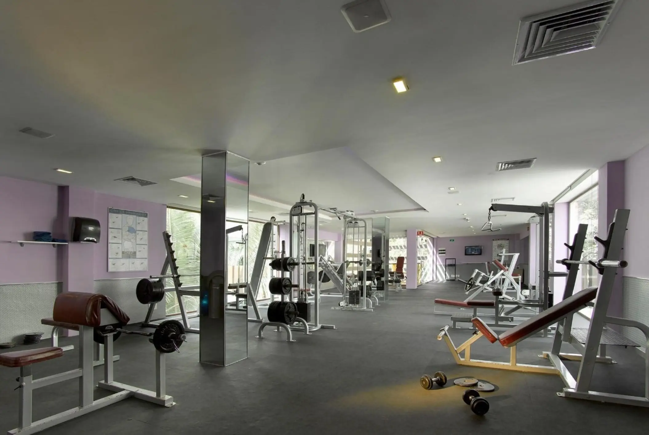 Fitness center with weight machines and dumbbells at Grand Palladium Vallarta, Puerto Vallarta