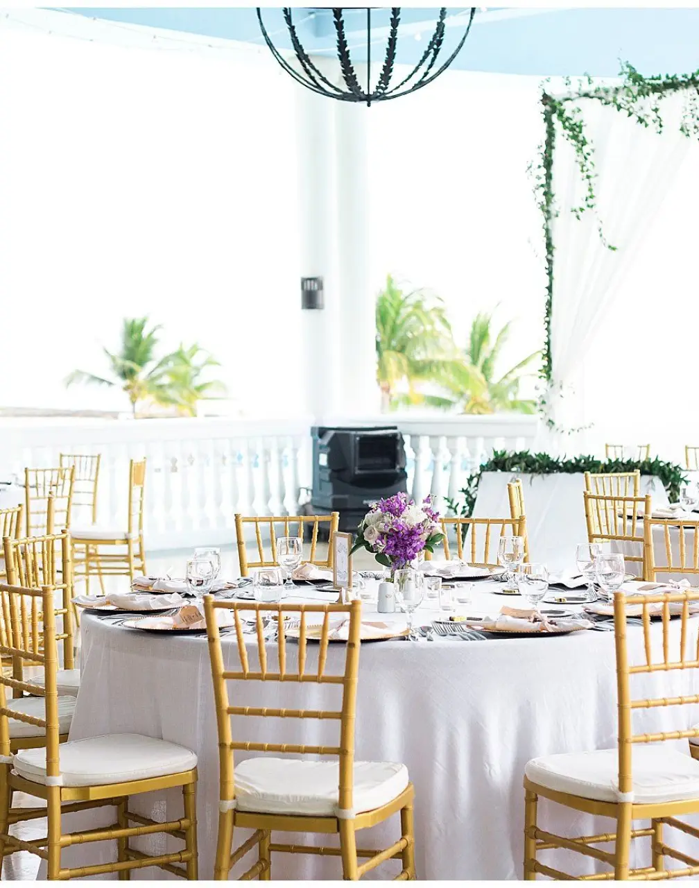 Terrace wedding reception with gold chairs and white linens at Grand Palladium Lady Hamilton, Ocho Rios