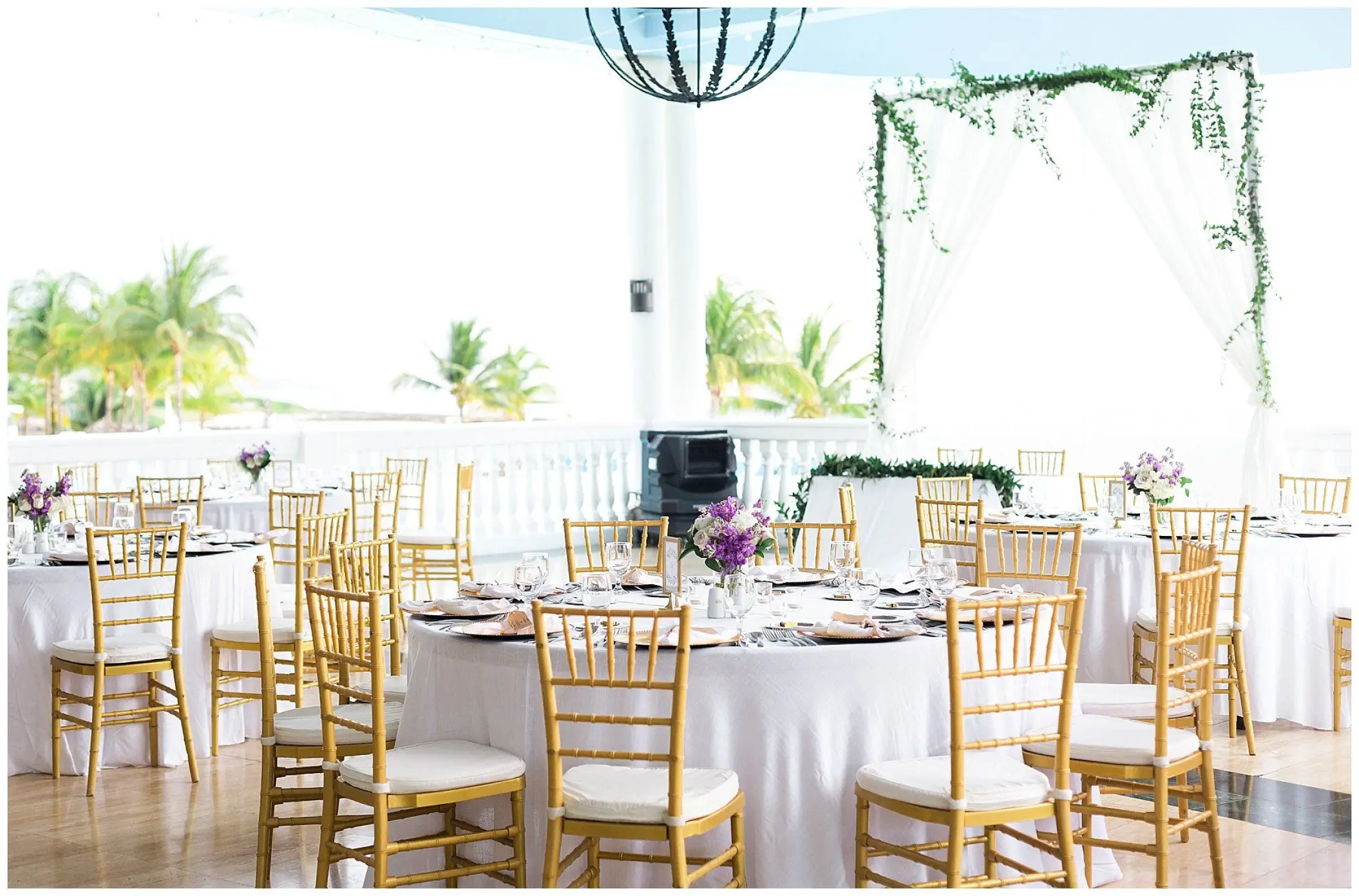 Terrace wedding reception with gold chairs and white linens at Grand Palladium Lady Hamilton, Ocho Rios