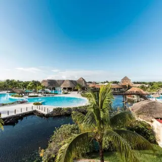 Overview of the pools and palm trees at Grand Palladium White Sand, Riviera Maya