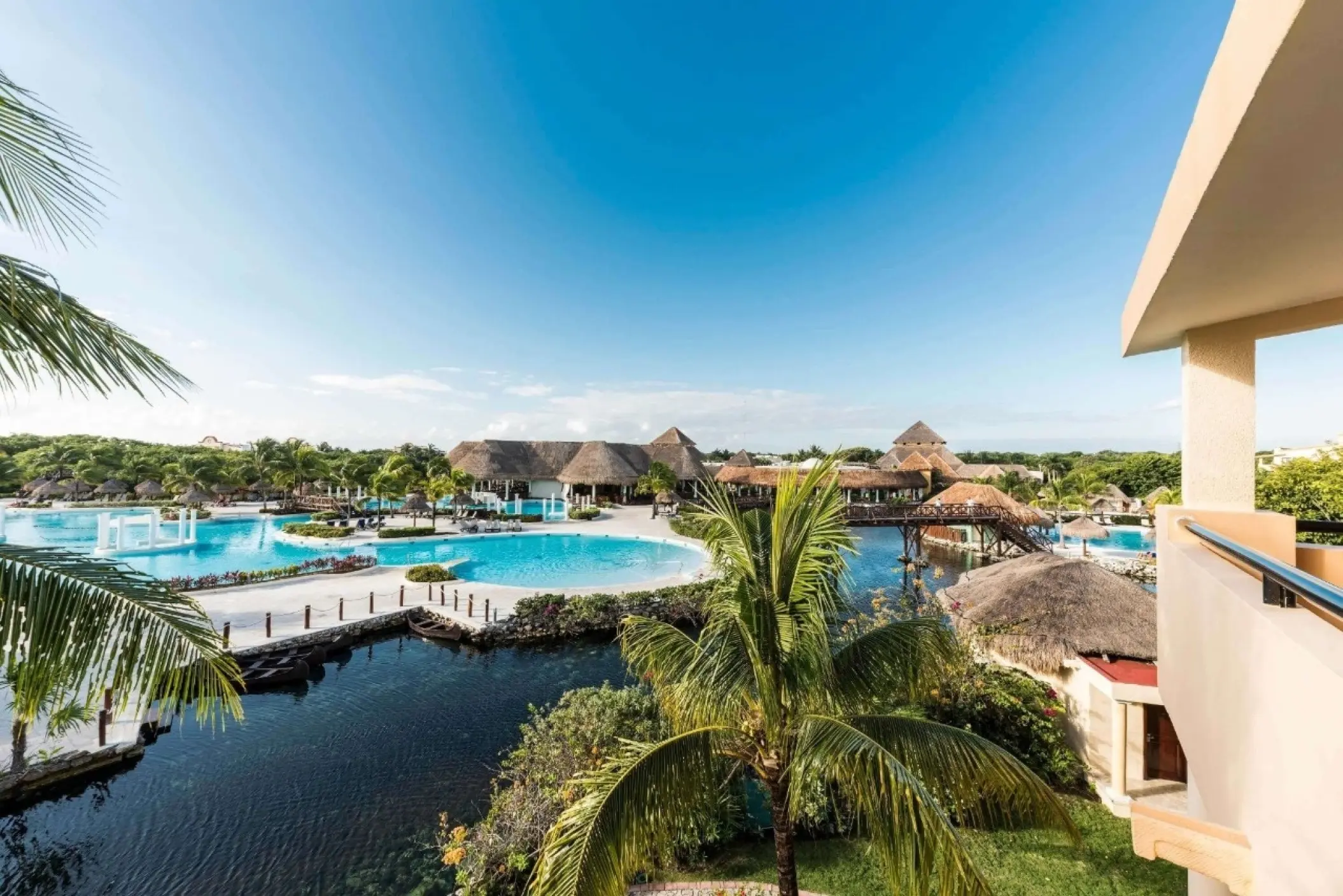 Overview of the pools and palm trees at Grand Palladium White Sand, Riviera Maya