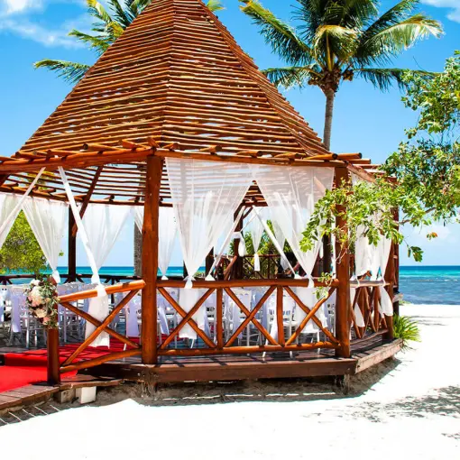 Beachfront wedding ceremony gazebo with red aisle runner at Grand Riviera Princess, Playa Del Carmen