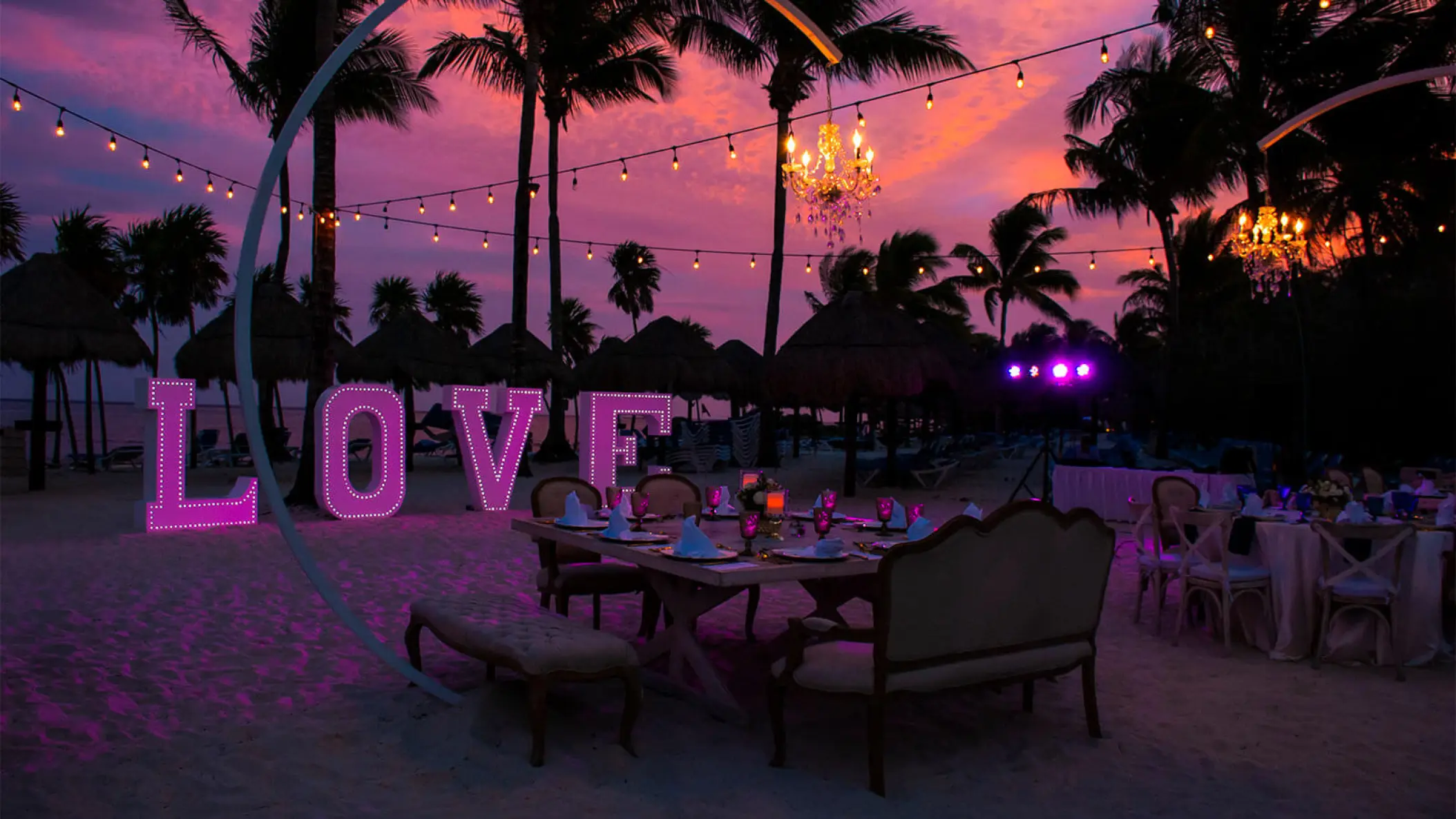 Beach wedding reception at Grand Riviera Princess, Playa Del Carmen with string lights and illuminated LOVE sign