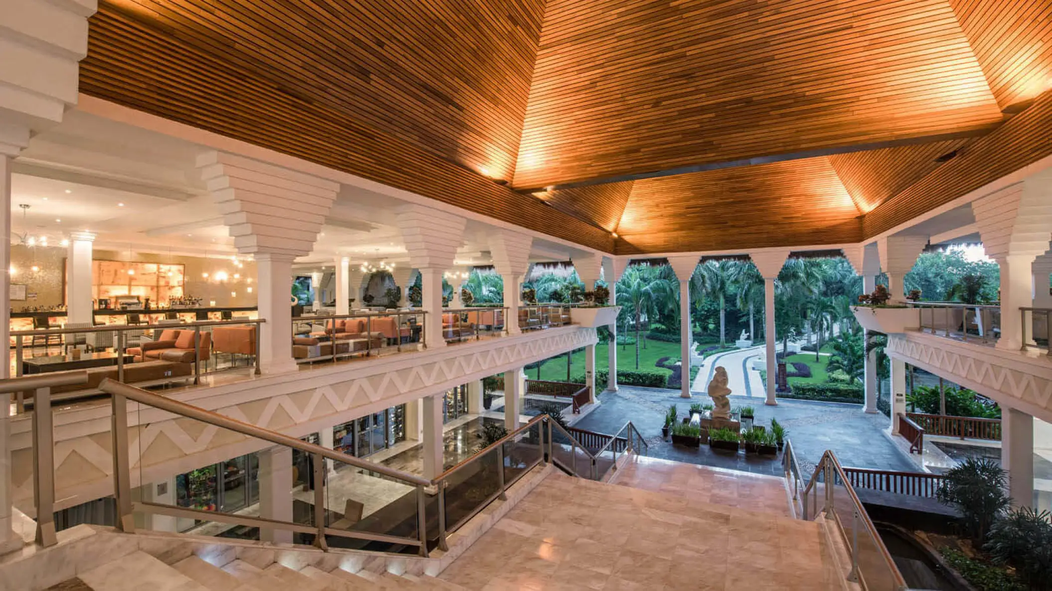 Grand Riviera Princess open-air lobby with a wooden ceiling and stairs overlooking the grounds, Playa Del Carmen