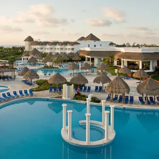 Grand Riviera Princess expansive pool area with palapas and lounge chairs, Playa Del Carmen