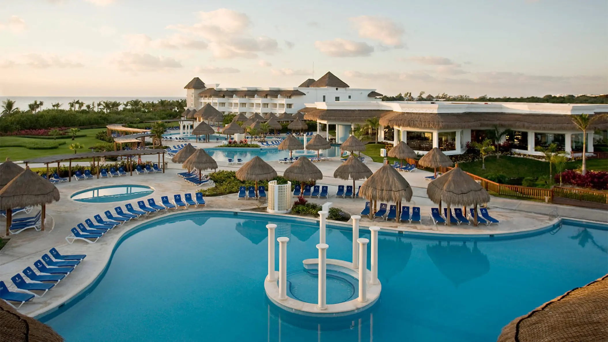 Grand Riviera Princess expansive pool area with palapas and lounge chairs, Playa Del Carmen