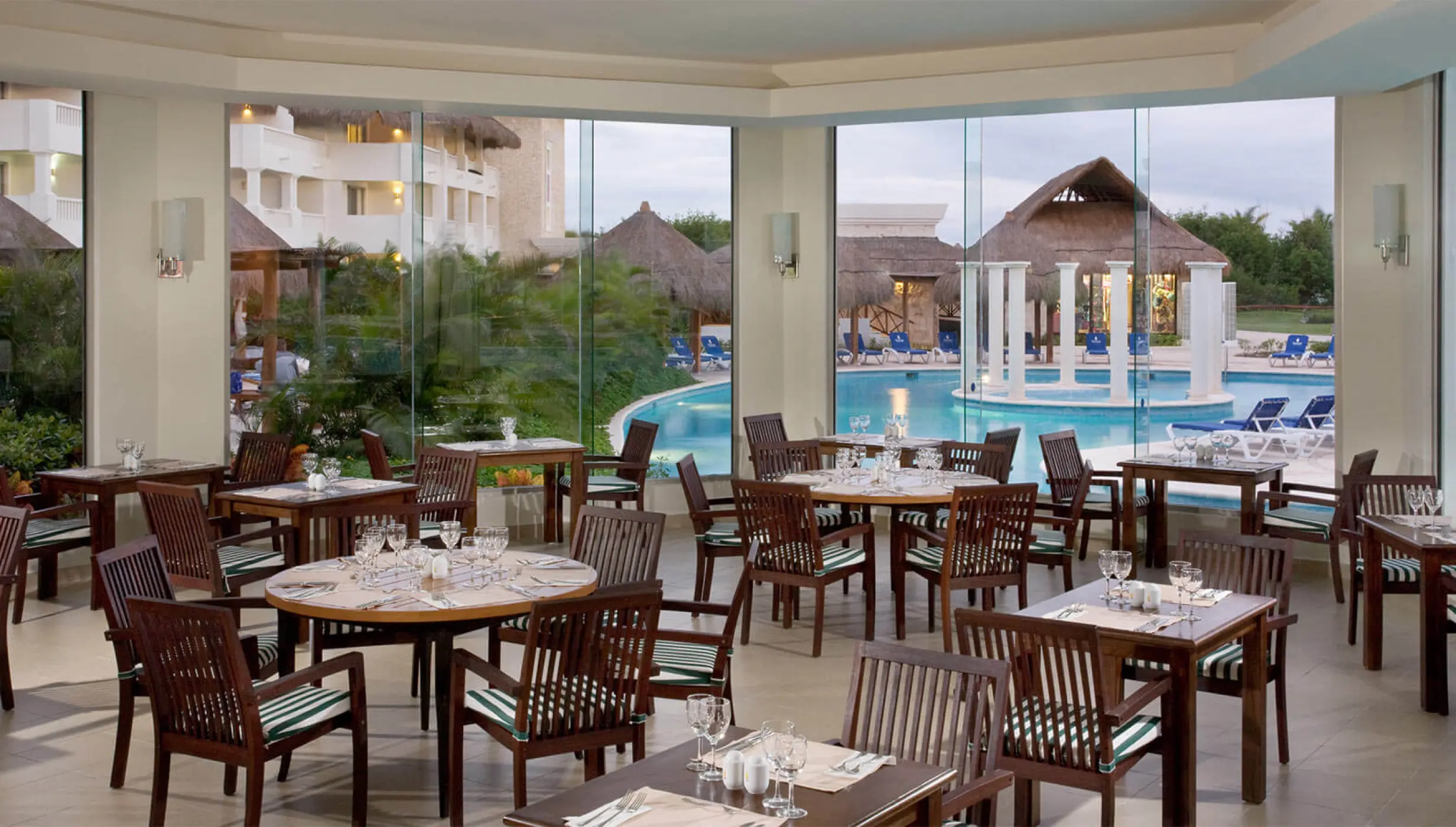 Indoor restaurant seating at Grand Riviera Princess overlooking the pool and gardens, Playa Del Carmen