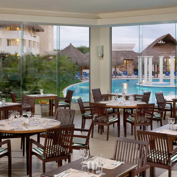 Indoor restaurant seating at Grand Riviera Princess overlooking the pool and gardens, Playa Del Carmen