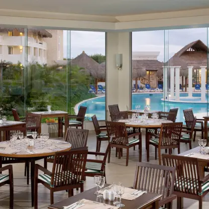 Indoor restaurant seating at Grand Riviera Princess overlooking the pool and gardens, Playa Del Carmen