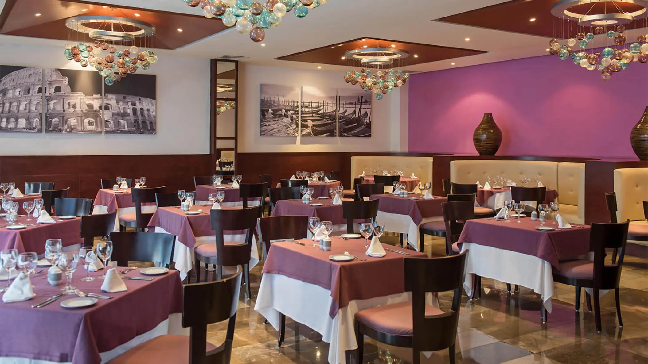 Indoor restaurant with purple tablecloths and modern chandeliers at Grand Riviera Princess, Playa Del Carmen