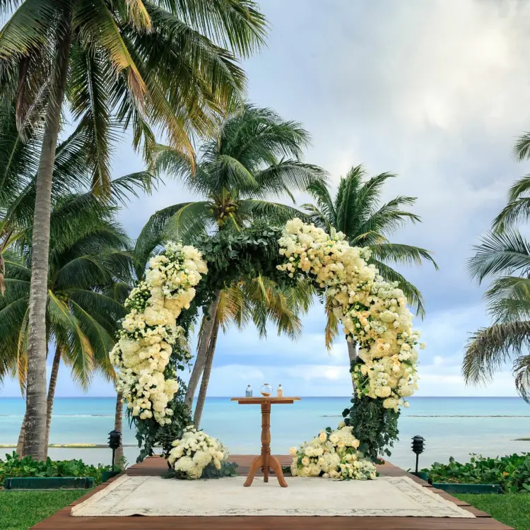 Circular floral wedding ceremony arch on the Grand Class deck at Grand Velas Riviera Maya