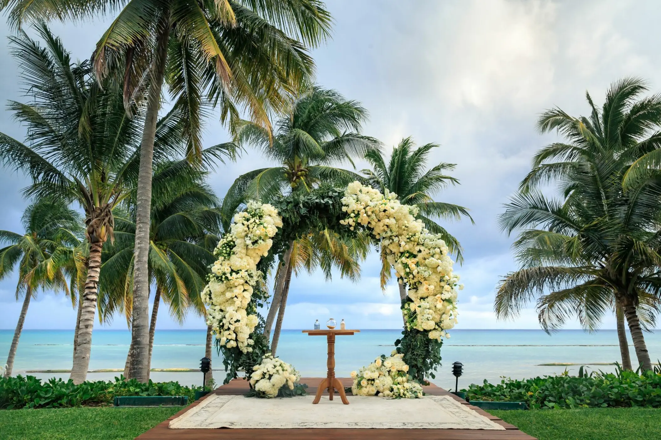 Circular floral wedding ceremony arch on the Grand Class deck at Grand Velas Riviera Maya