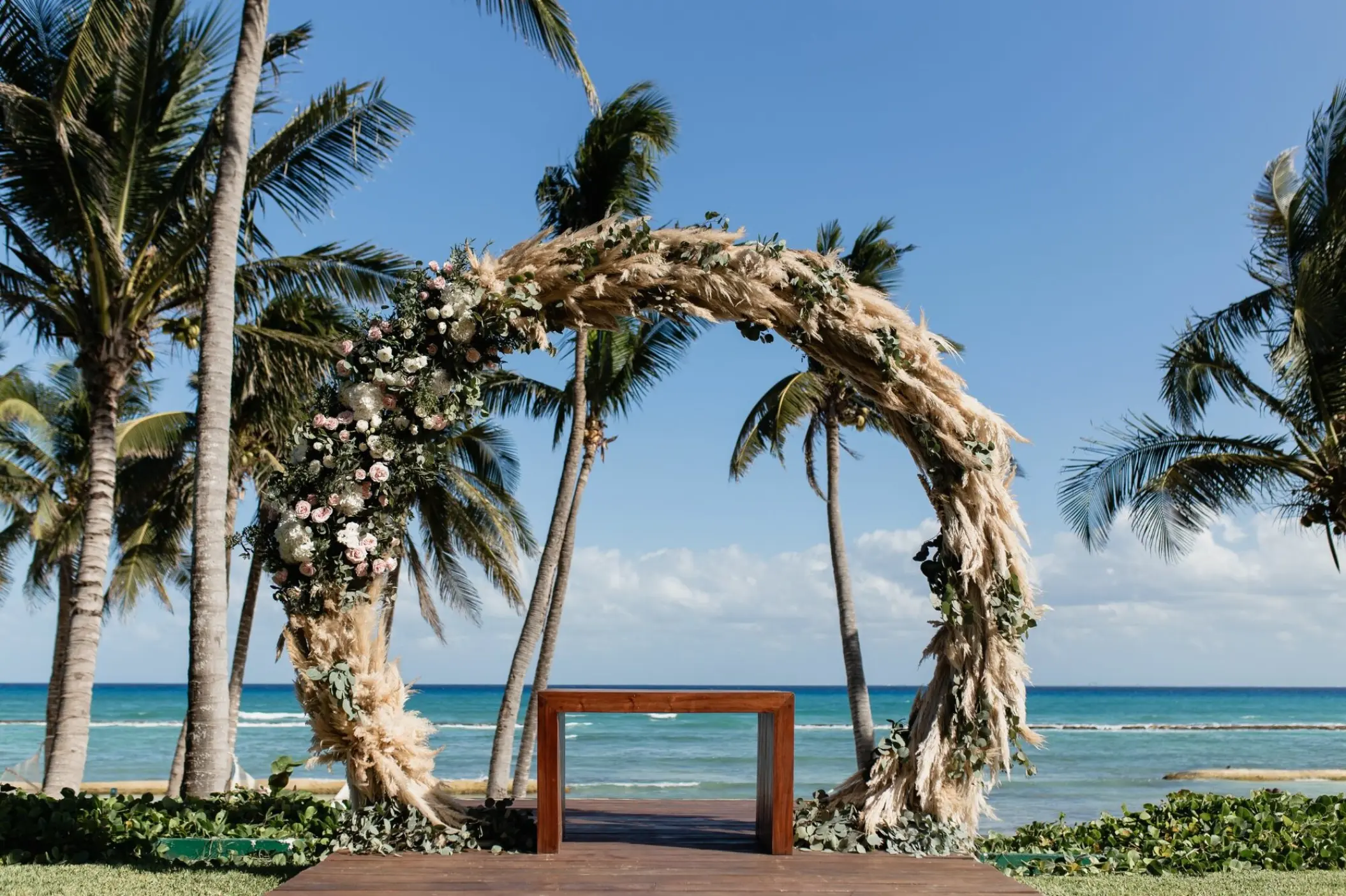 Circular pampas grass wedding ceremony arch at Grand Velas Riviera Maya, Riviera Maya